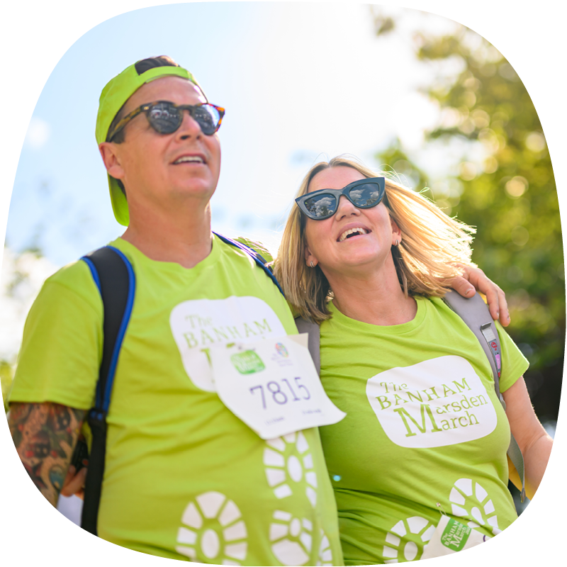 A couple at the Banham Marsden March. They're both wearing the green t-shirts, smiling with their arms around each other